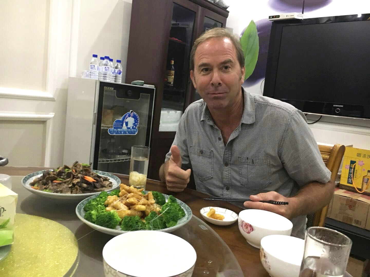 David enjoying multi-course traditional Chinese meal in Chinese processing facility office.