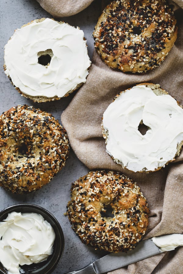 Homemade gluten free everything seed mix bagels with cream cheese.