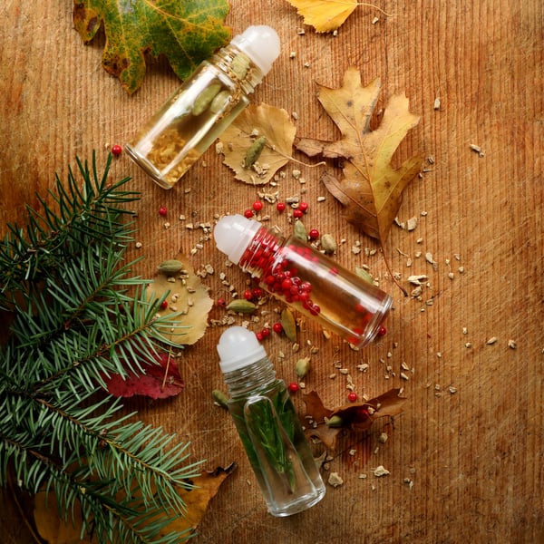 Essential oils blends for fall in roll-top bottles.