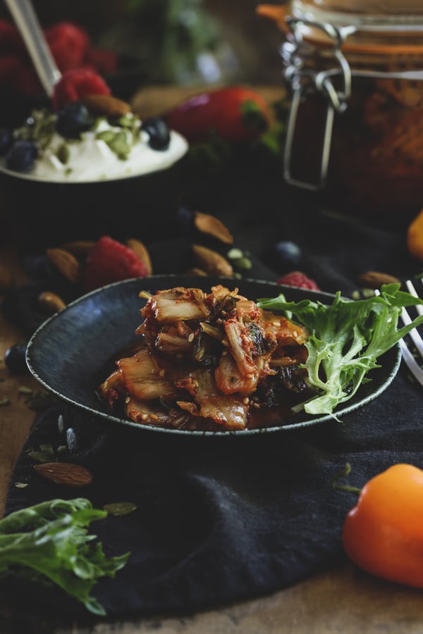 Plate of kimchi and fresh colorful ingredients.