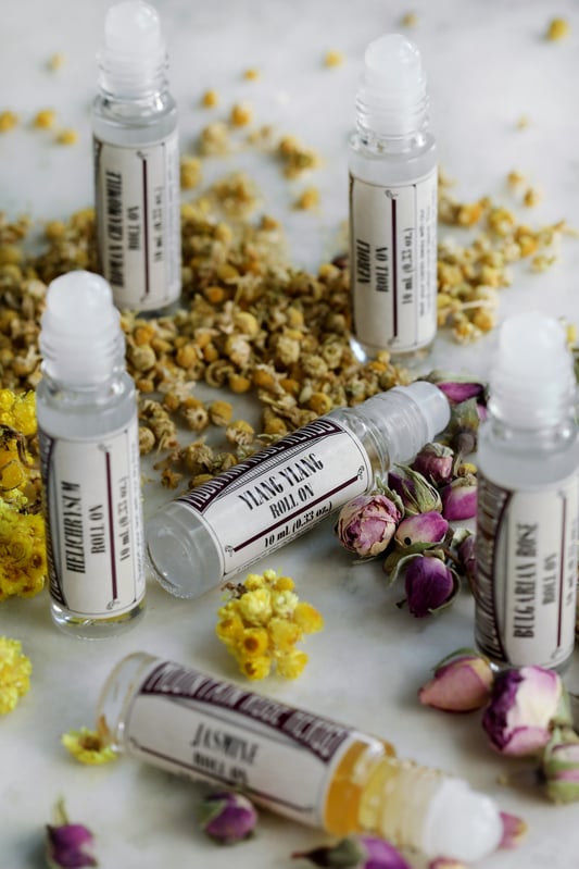 Floral essential oil roll-on bottles include Bulgarian rose, ylang ylang, jasmine, helichrysum, neroli, and Roman chamomile. 