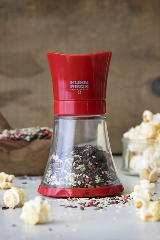 Kuhn Rikon spice grinder with sesame seeds and dulse flakes next to popcorn kernals