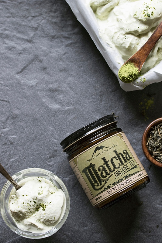 Bowl of matcha green tea ice cream with matcha powder and spoon