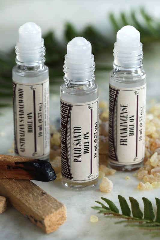 Grounding essential oil roll-on bottles include palo santo, frankencense, and Austrailian sandalwood essential oils.