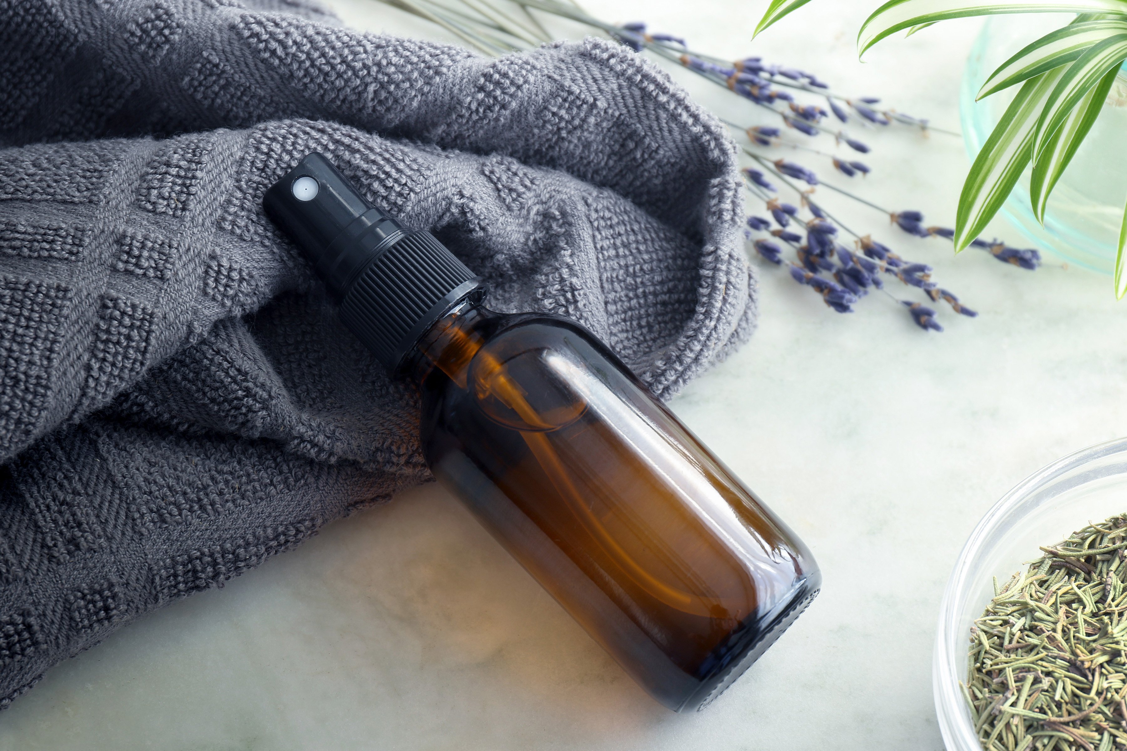 An amber spray bottle filled with a lavender rosemary herbal vinegar which can be used for cleaning as well as skin care. Herbal vinegars are simple to make and provide many uses around the home. 