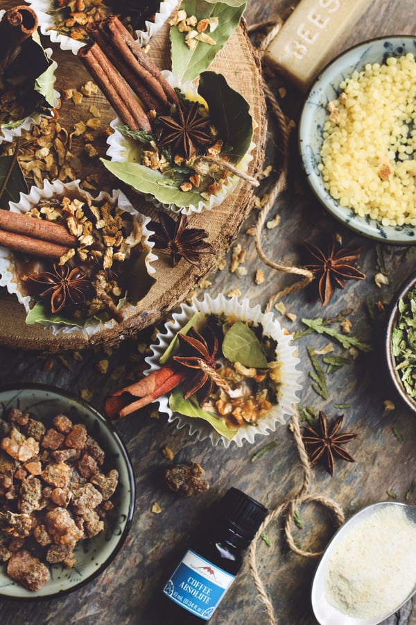 Homemade fire starters with herbs and beeswax on a rustic table. 