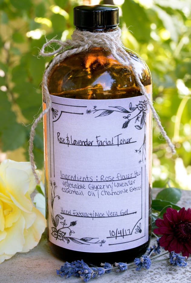 Bottle of Rose Flower toner with handmade label sitting outside