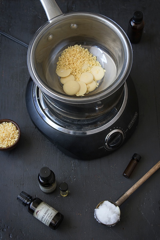 Natural beeswax and butters warming in a double-boiler
