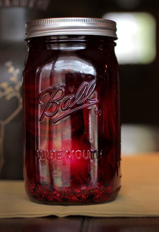 bright magenta pickled curry deviled eggs in a mason jar