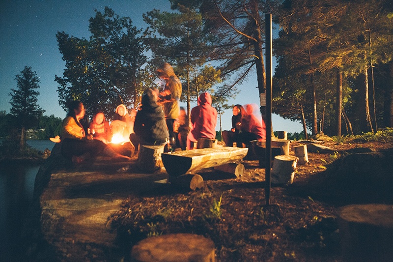 Family and friends camping outdoors