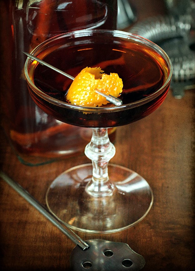 Orange Spice Manhattan with Orange Peel Garnish on tabletop