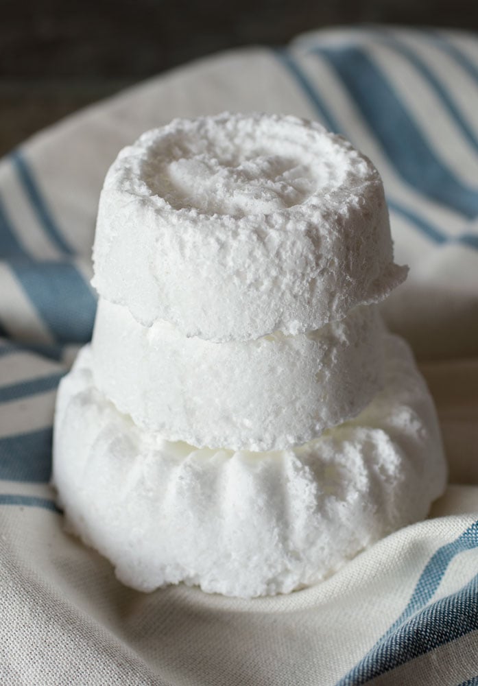 White bath bombs on blue and white striped towel