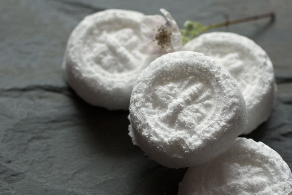 Homemade white toilet bombs on a countertop