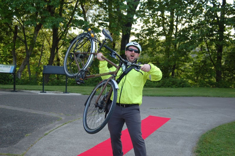 Cyclist from the Fashion Show Poses With Bike