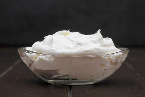 whipped body butter recipe made with shea oil in bowl on black background