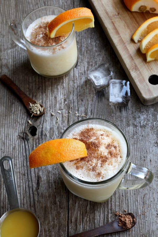 Glass mugs filled with with kava pina colada drink and recipe ingredients