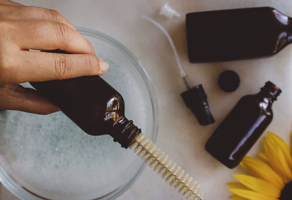 hand cleaning glass bottle with bottle brush