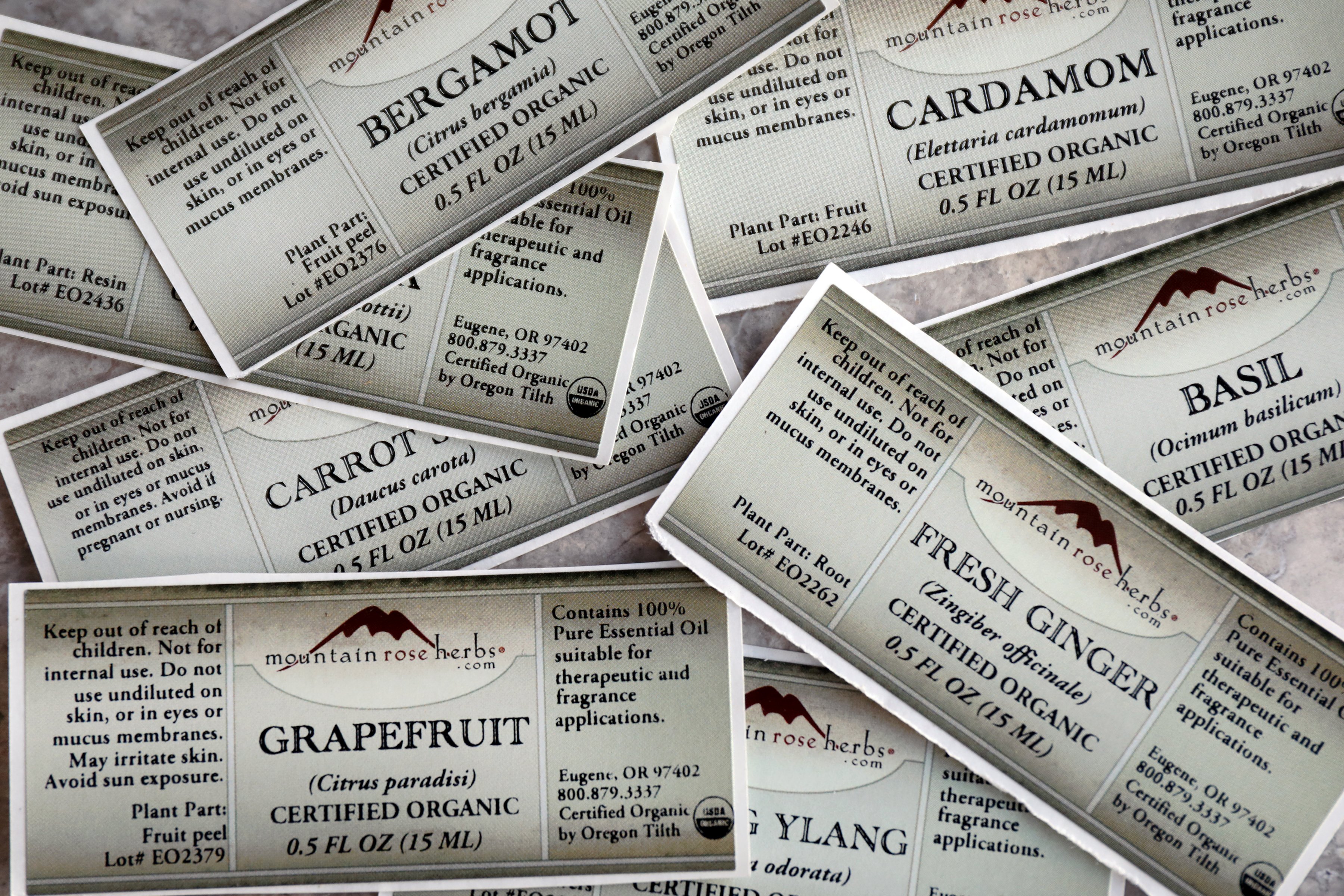 Several essential oil labels scattered on table.
