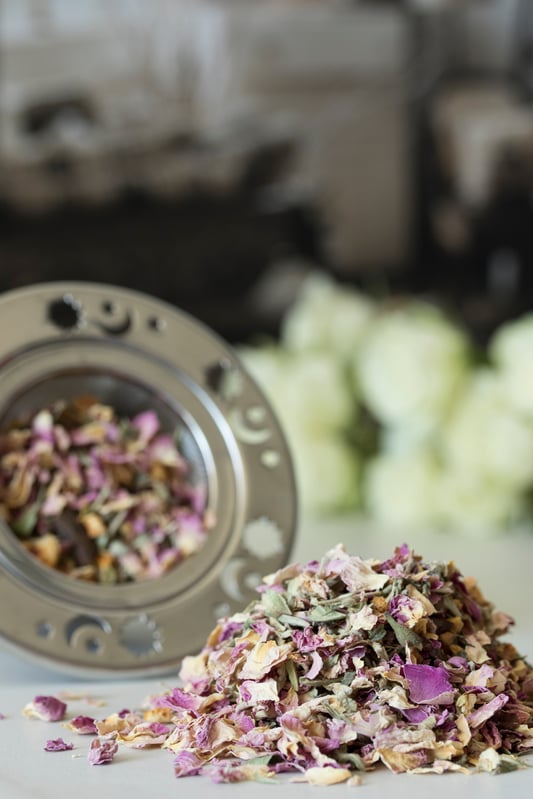 Loose-leaf love tea next to celestial tea strainer