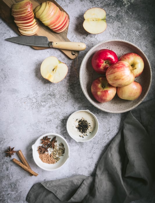 Ingredients for a rustic autumn apple tart. Fresh organic apples and a spice blend of fennel, cinnamon, galangal, and start anise, plus some vanilla black tea.