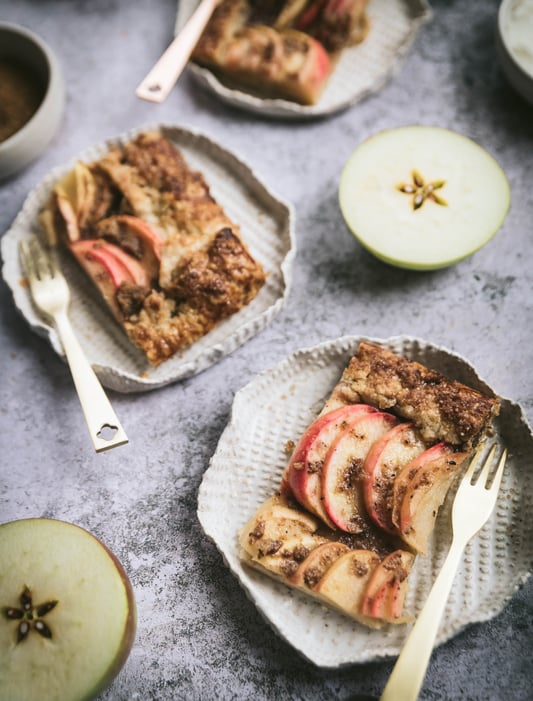 Serving a rustic apple tart made with organic apples and spices like cinnamon, fennel, galangal, and star anise. 