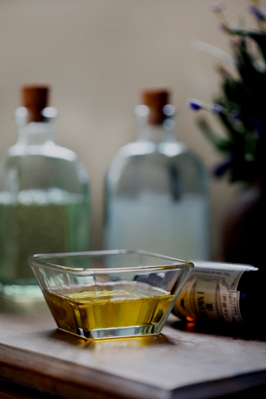 Homemade natural makeup remover in glass dish.