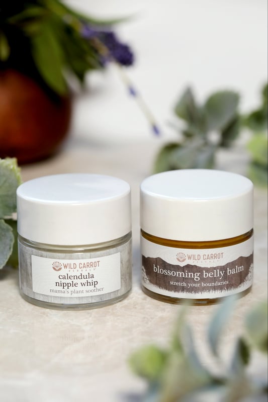 Jars of natural belly balm and nursing cream for new moms. 