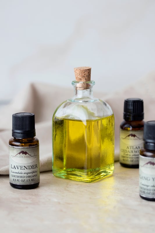 A love-inspired massage oil uses essential oils of lavender, atlas cedarwood, and ylang ylang along with jojoba oil to create a golden oil for relaxing massages. 