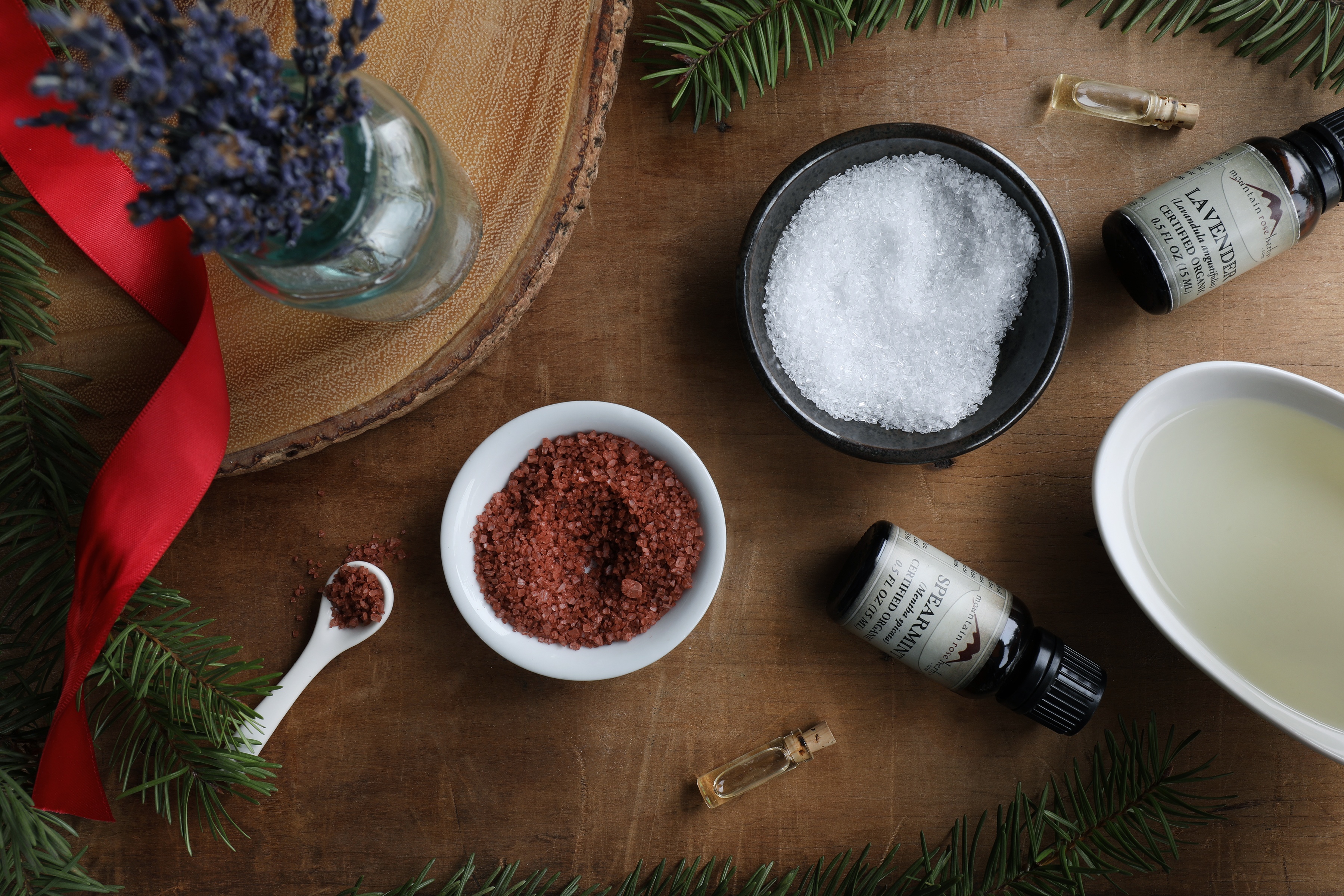 Displayed colorful salts and essential oil bottles with holiday decor