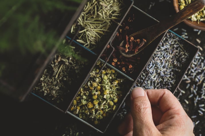 Sectioned display filled with colorful herbs