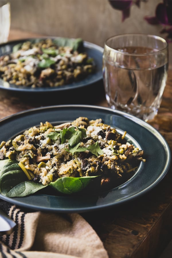 Two plates of healthy and nourishing food and glasses of water. 