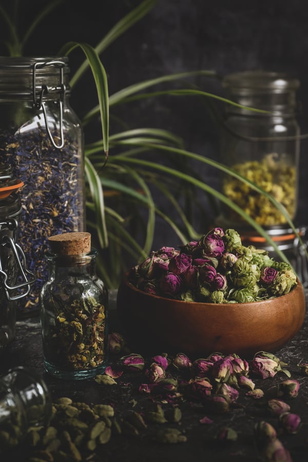 Beautiful herbs piled on a table and in jars.