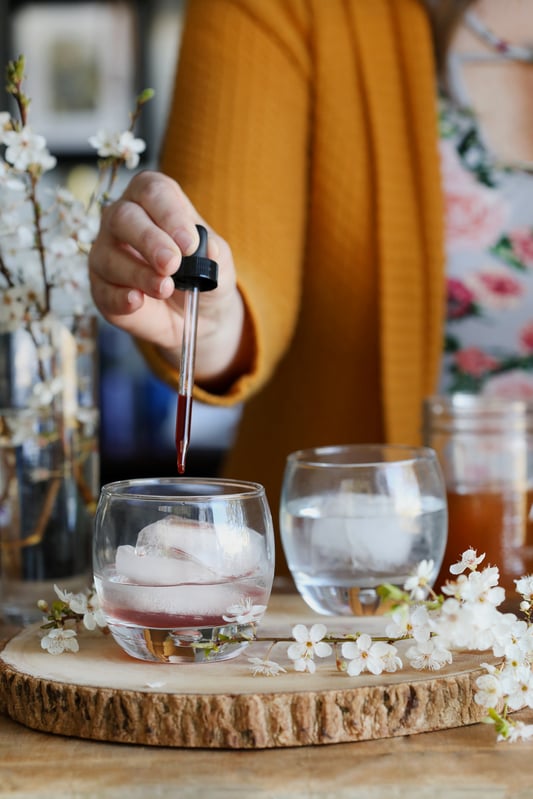 Using a dropper to add a finished herbal oxymel to beverages is a simple way to incorporate herbs into your wellness routine. 