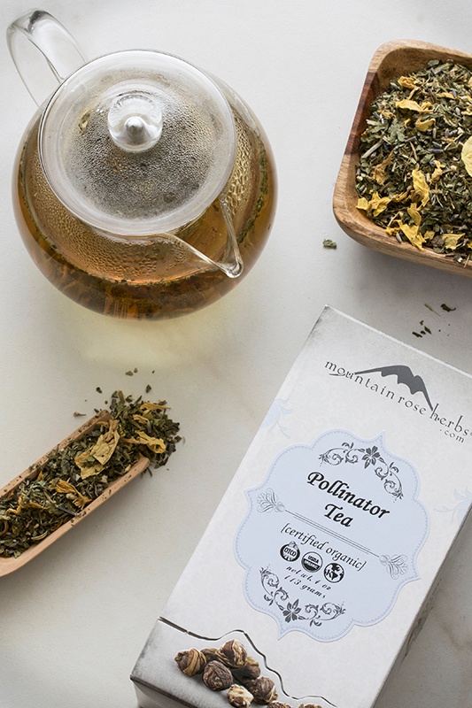 Certified organic pollinator tea in box and brewed in glass teapot