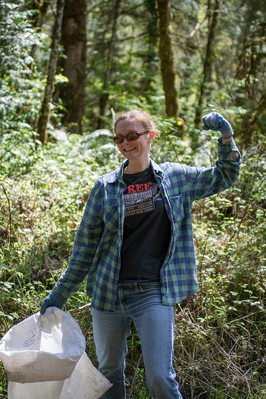 Mountain Rose Herbs staff member in the woods doing river and trash clean up