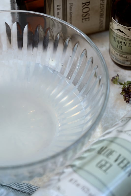 Organic rose hydrosol in glass bowl with vitamin E oil.