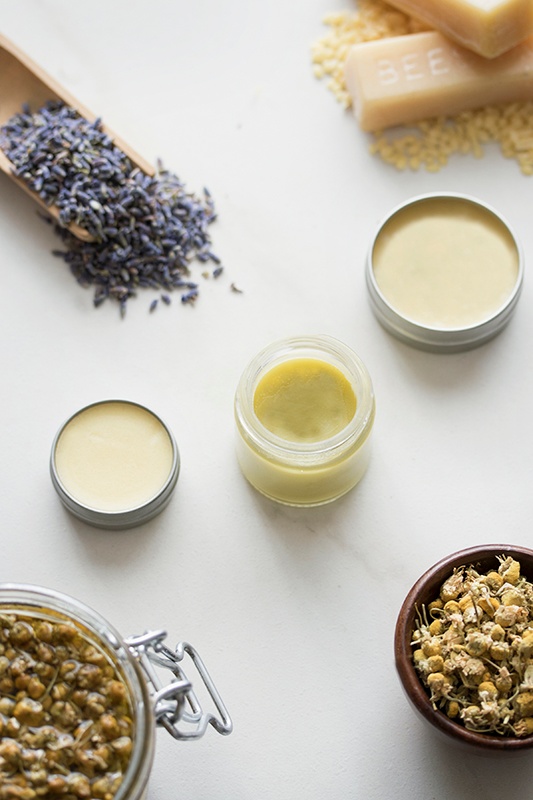 Homemade salve with array of botanical ingredients.