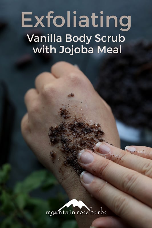 A woman using a finished DIY body scrub with vanilla, honey, and jojoba meal. Coarse sea salt is exfoliating for the skin and sweet almond oil moisturizes. 