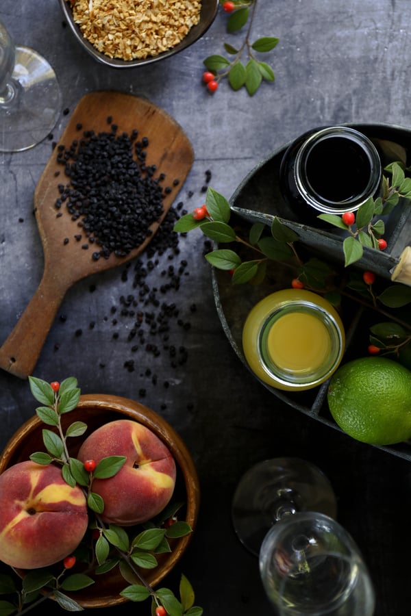 ELDERBERRIES, PEACHES, LIME AND OTHER INGREDIENTS TO MAKE AN ELDERBERRY VODKA EXTRACTION FOR ELDER BELLINIS