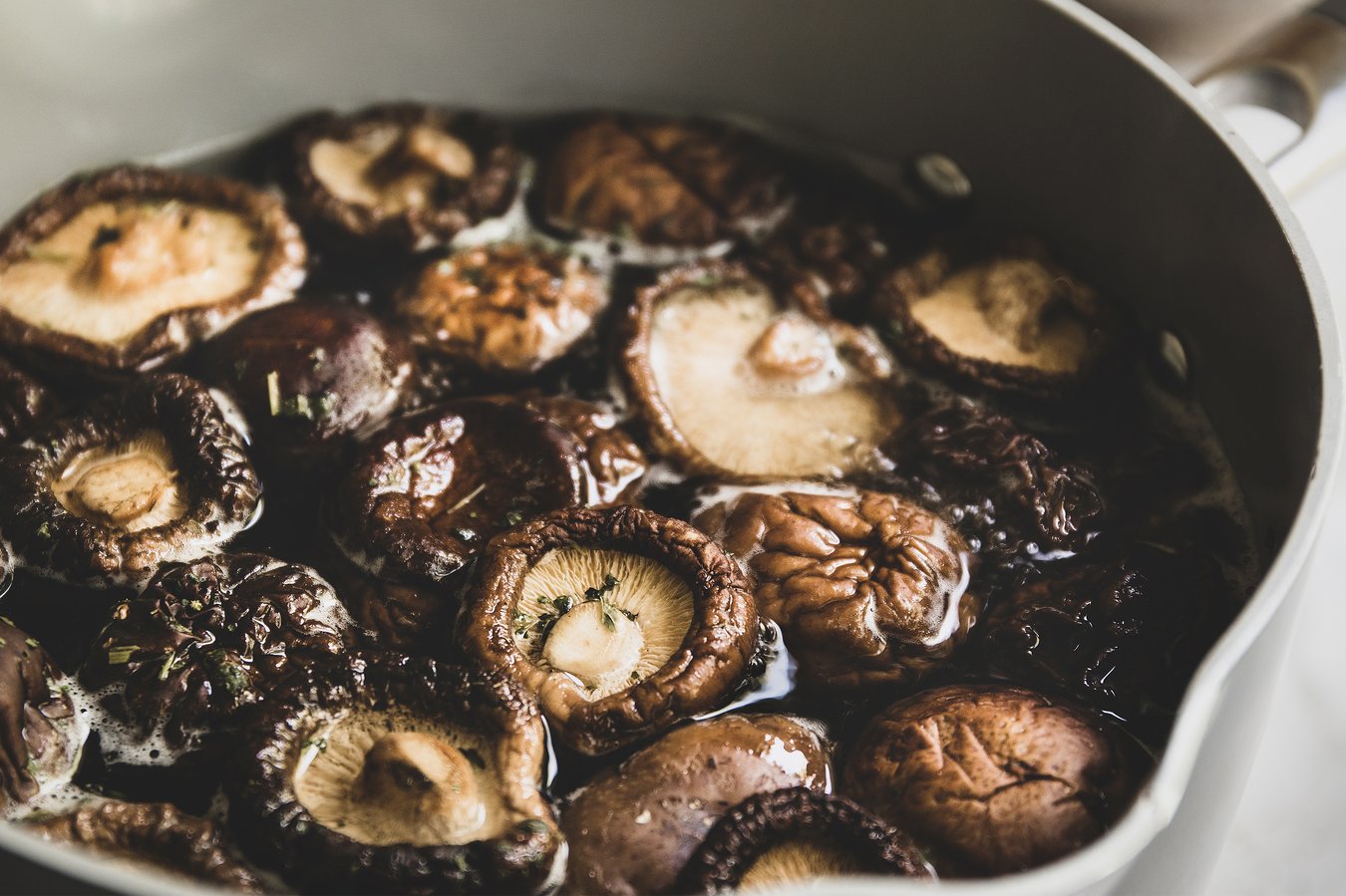 Dried shiitake mushrooms in a pot of water.