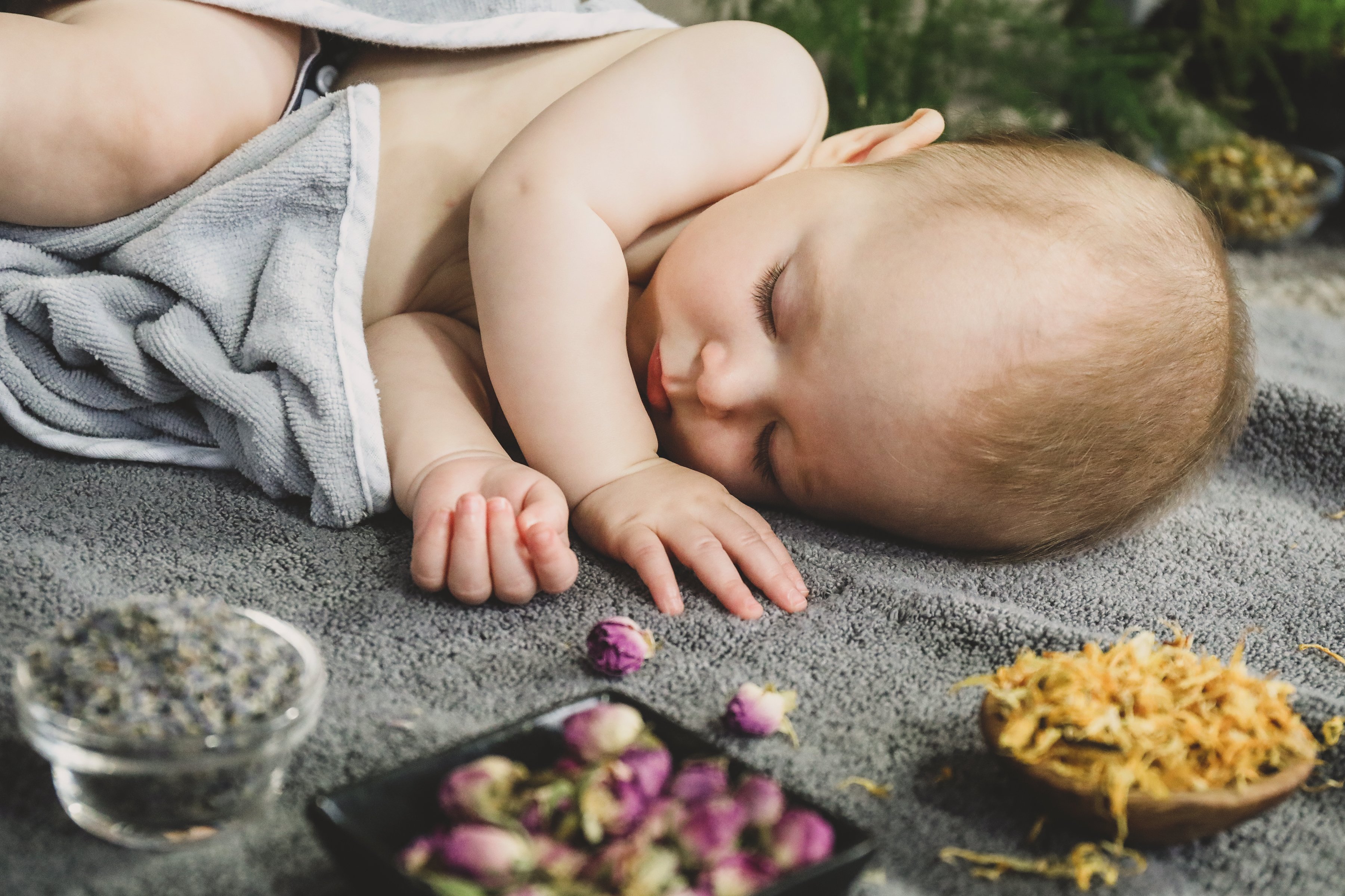 Sleepy baby with herbs.