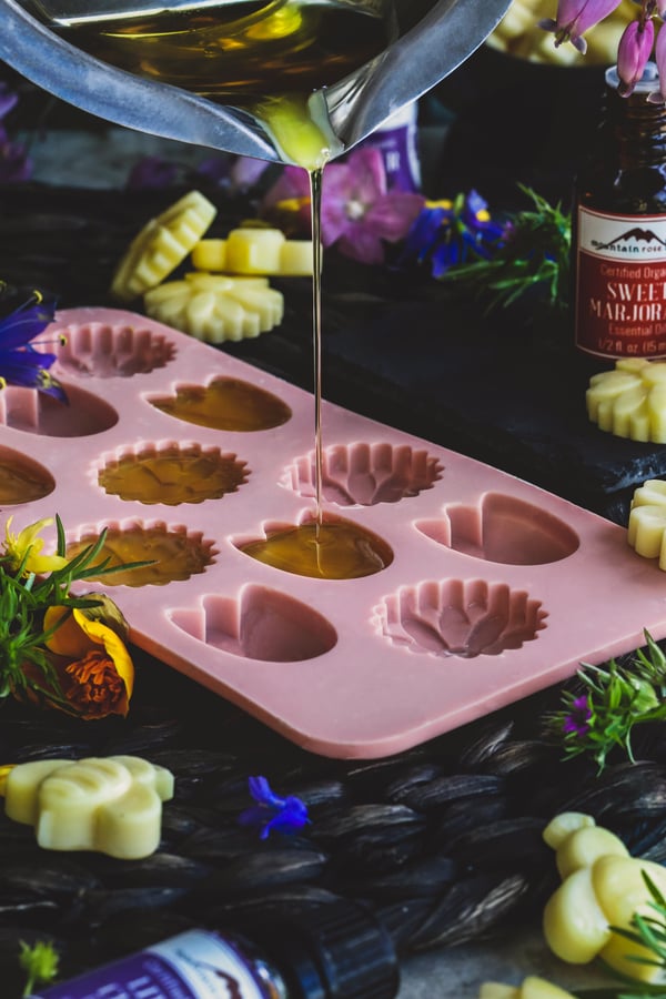 How to Make Wax Melts- Pouring wax mixture into flower shaped molds. 