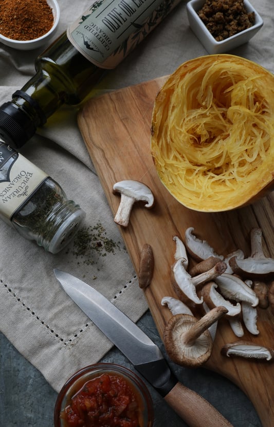 Ingredients laying out on cutting board to make spaghetti squash bowls