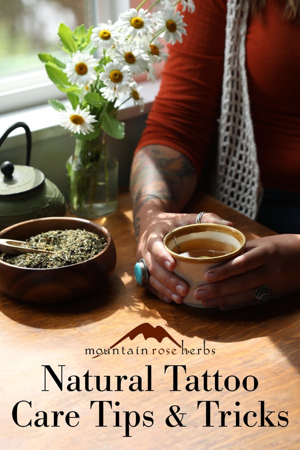 Pinterest link to Mountain Rose Herbs. A woman sitting down with a bowl of herbal tea and a freshly brewed cup. 