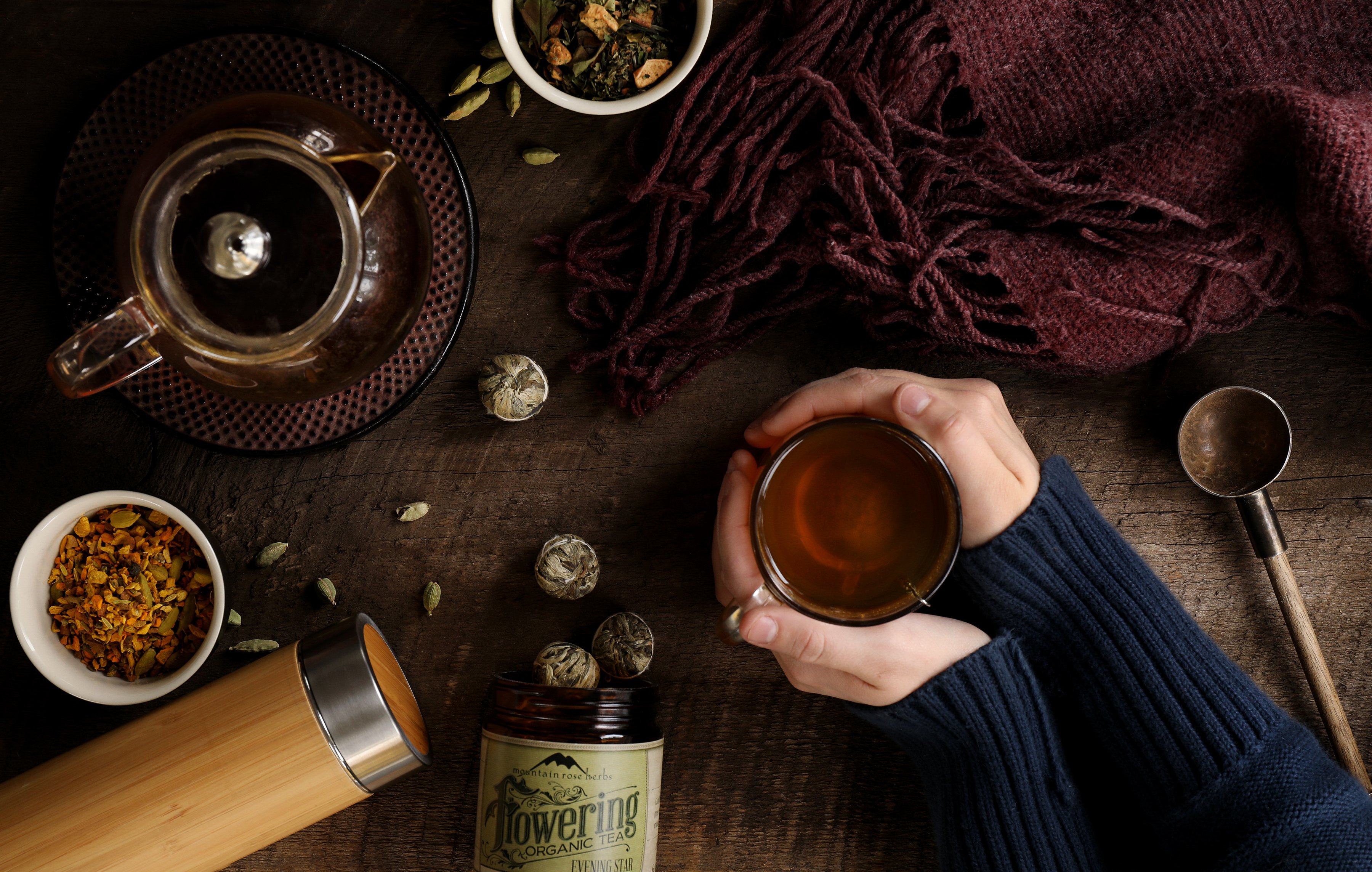 Gifts for tea lovers include flowering teas and a clear glass teapot, travel tea tumblers in bamboo, and other accessories for any tea enthusiast.