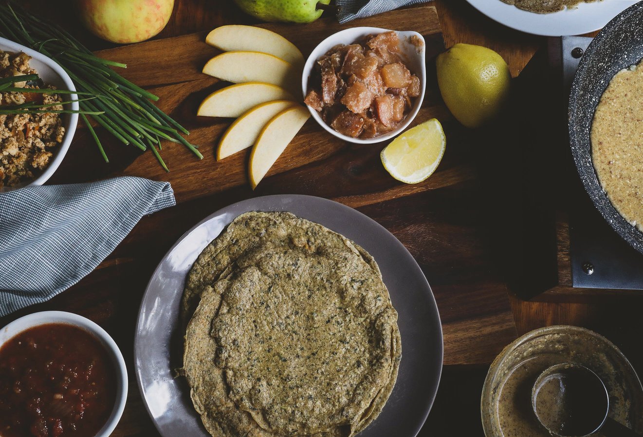 Gluten-free coconut buckwheat crepes on a plate with apples and pears