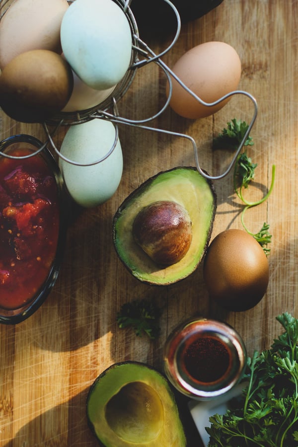 Avocados and farm fresh eggs ready to make keto-friendly spicy avo eggs