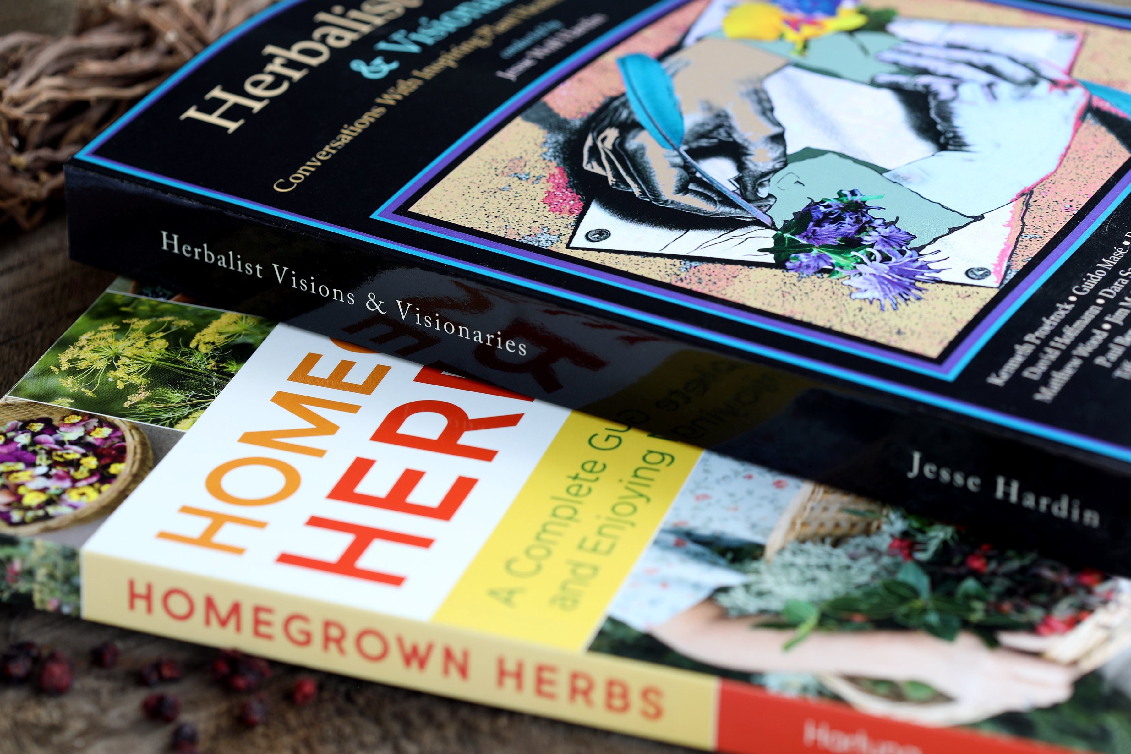 Close up photo of two colorful books on herbs and herbalists