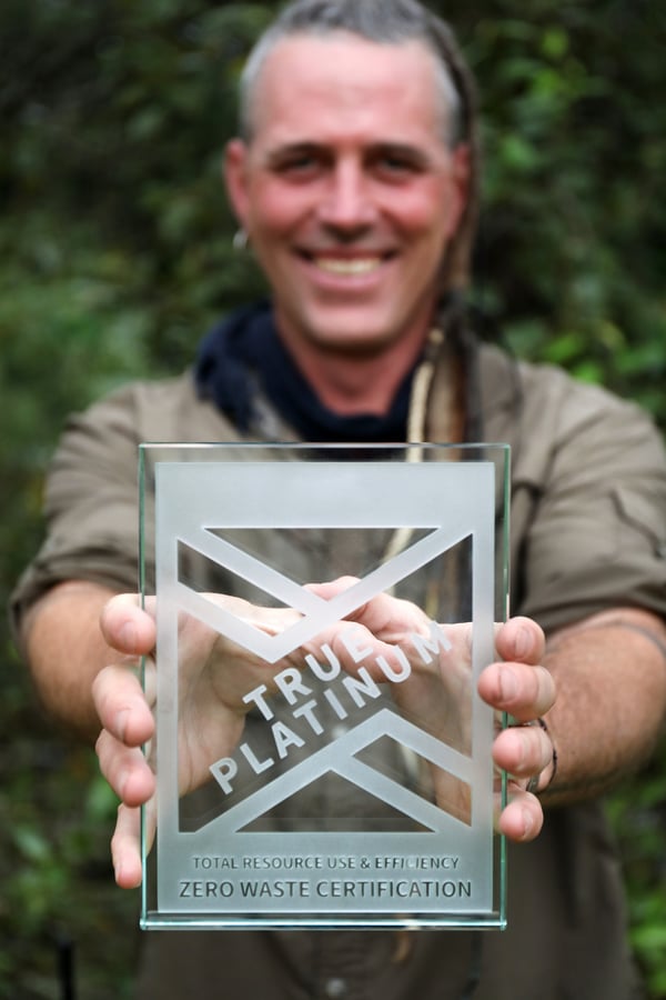 Shawn Donille, Vice President of Mountain Rose Herbs, holding the Platinum winner TRUE Zero Waste company award.