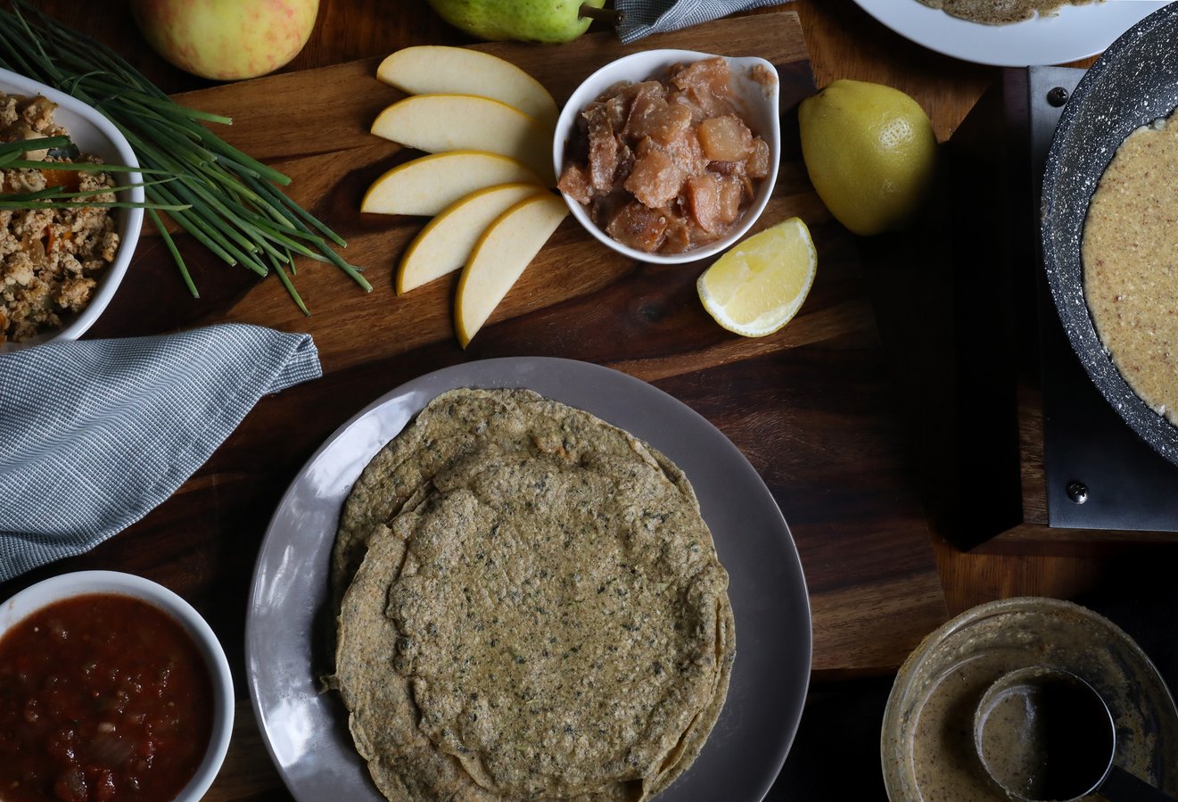 Gluten-free coconut buckwheat crepes on a plate with apple filling and sliced pears